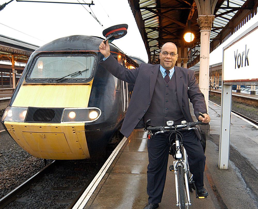 A railway worker with his bike beside a train at York station.