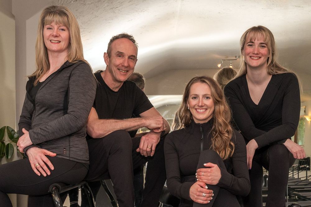 A group shot of four Pilates instructors.