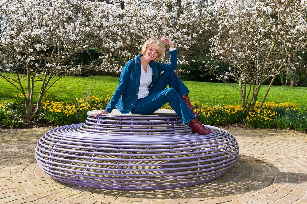 A stylish shoot for Midlife Magic, posed on a wire seat at Rudding Park.