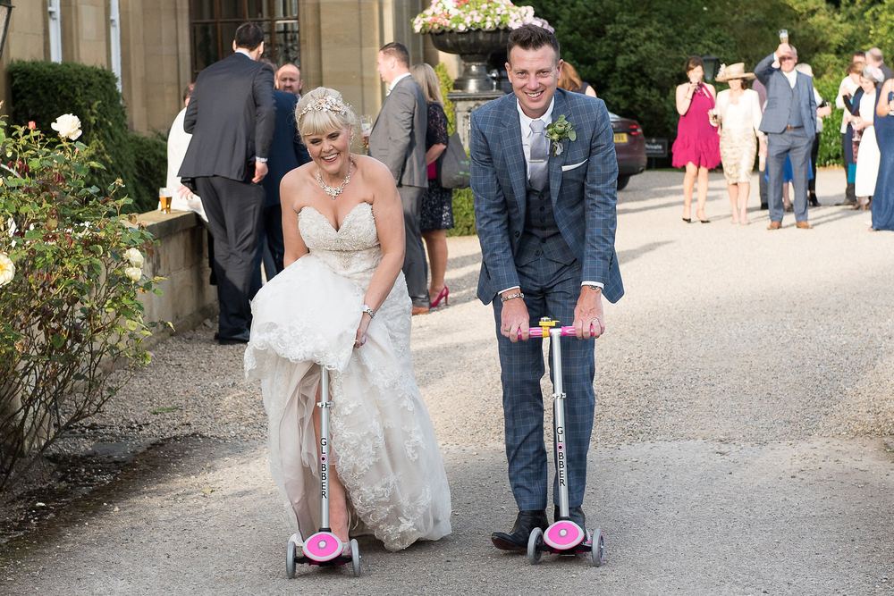 Elaine & Matty whizz about on the flower girls' scooters.