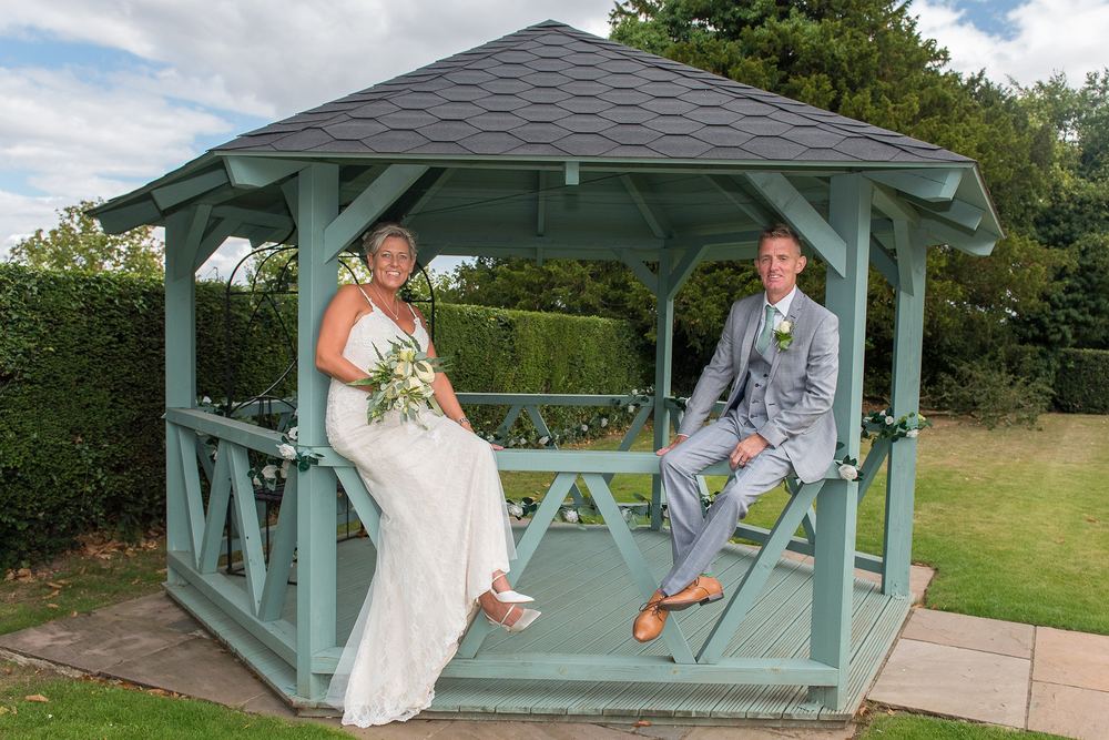 Helene & Rob sit at the gazebo at Burythorpe House.