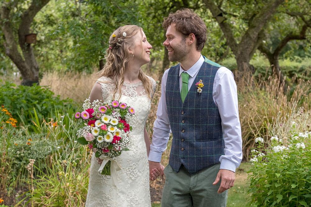 Rebecca & Edward walk through the countryside after their wedding.