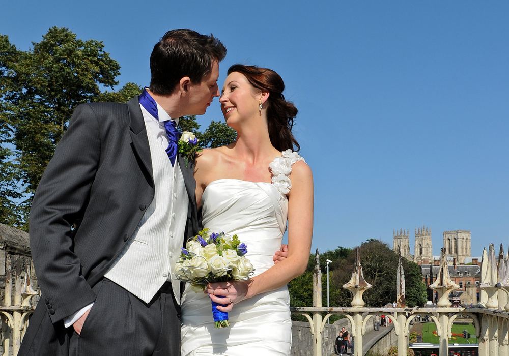 Katrina & Adam on the city walls with York Minster behind, after their wedding at The Grand Hotel.