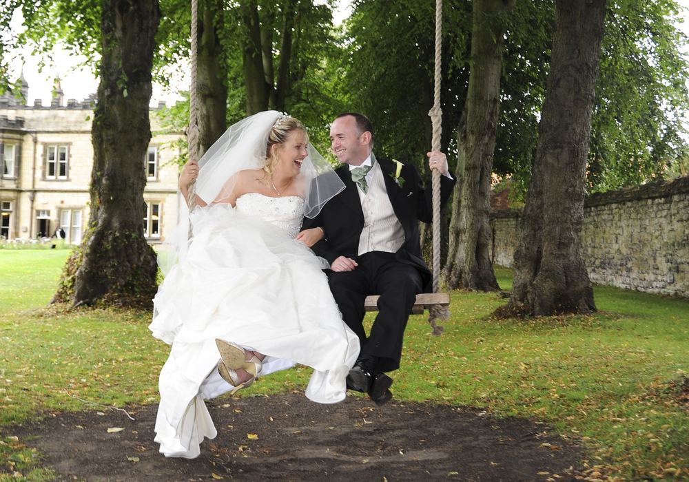 Newly-weds Laura & Craig have fun on a tree swing at The Old Lodge, Malton.