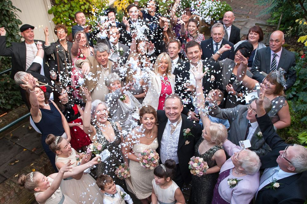 An overhead shot of all the wedding guests throwing confetti at York Pavilion Hotel, Fulford.