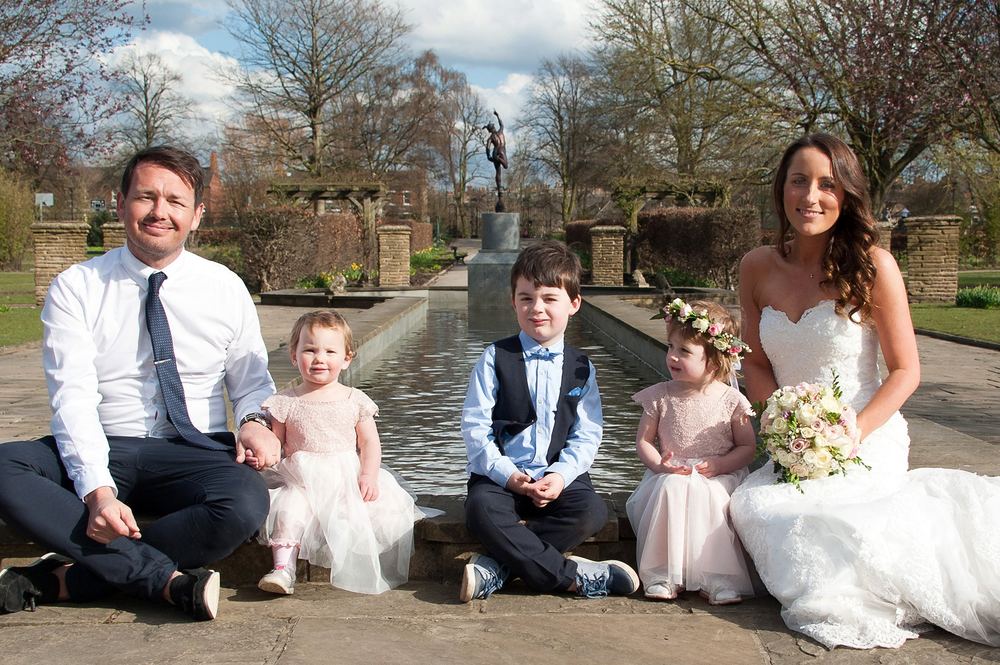 A family photo of Becky & Paul in Rowntree Park, York, on their wedding day.