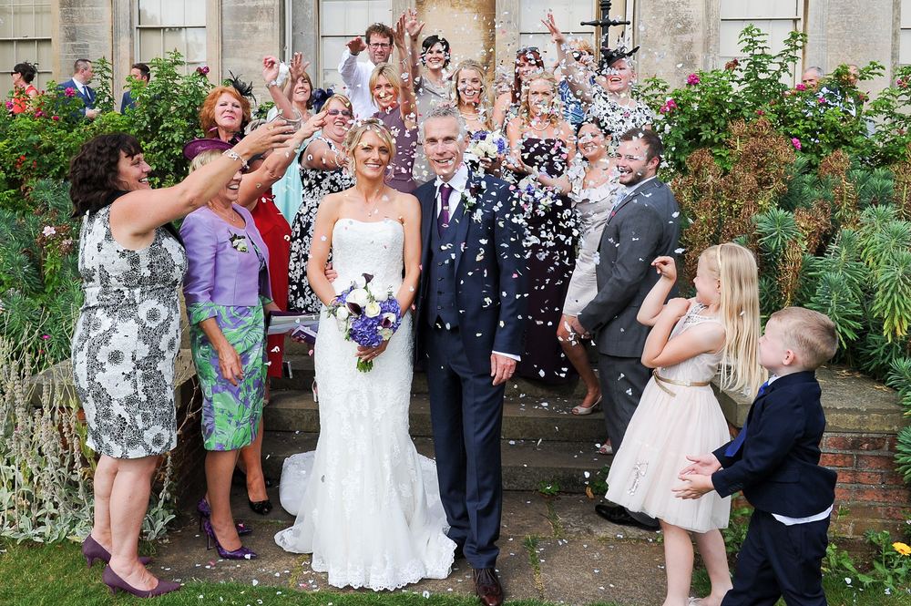 Guests throw confetti at Kathy & Sean's wedding at Normanby Hall, Scunthorpe.