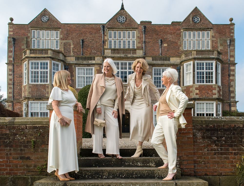 A group of stylish friends, all dressed in cream, at Goldsborough Hall.