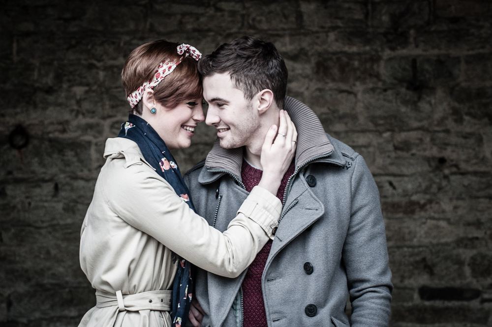 A young couple look adoringly into each other's eyes.
